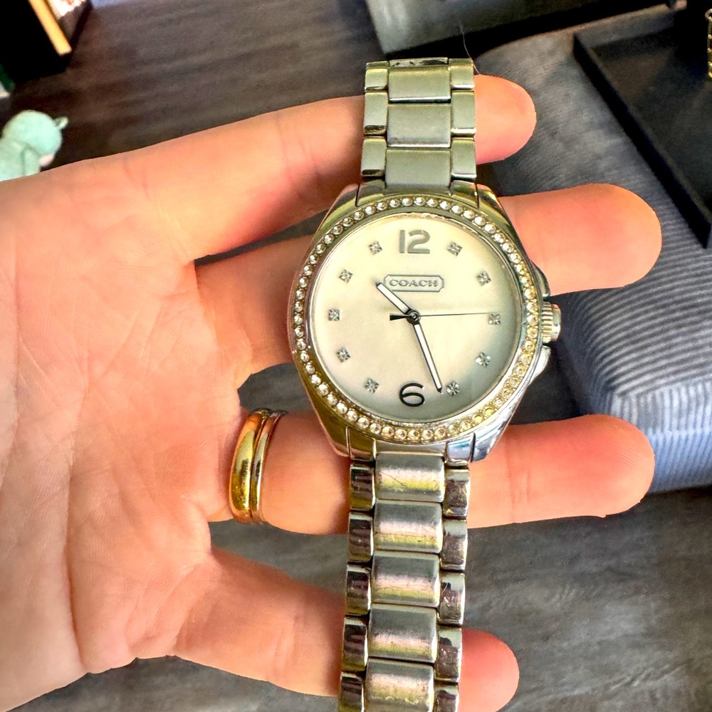 Coach watch, silver, small diamonds around. Beautiful! Needs new battery.